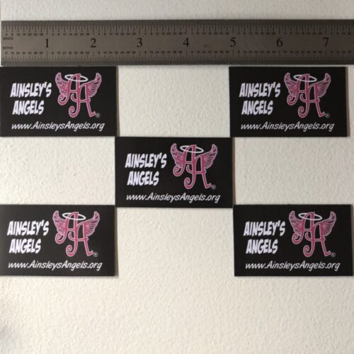five Ainsley’s Angels of America cards being measured by a ruler