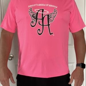 pink shirt with Ainsley’s Angels of America’s logo in front
